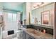 Charming bathroom with custom vanity, lighting, and bathtub with shower at 6678 S Arapahoe Dr, Littleton, CO 80120