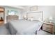 Bright bedroom features a plush bed, soft bedding, and modern decor at 6678 S Arapahoe Dr, Littleton, CO 80120