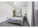 Bright bedroom featuring neutral tones, a ceiling fan, and a window providing natural light at 6678 S Arapahoe Dr, Littleton, CO 80120
