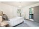 Relaxing bedroom with chandelier, neutral colors, and natural light at 6678 S Arapahoe Dr, Littleton, CO 80120