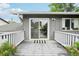 Deck featuring a sliding door, white railing, grey boards, and potted plants at 6678 S Arapahoe Dr, Littleton, CO 80120