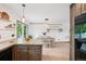Open-concept kitchen with a view of the light-filled dining area featuring modern accents at 6678 S Arapahoe Dr, Littleton, CO 80120