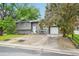 Attractive gray two-story home featuring a well-maintained lawn and a convenient driveway at 6678 S Arapahoe Dr, Littleton, CO 80120