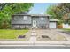 Charming two-story home featuring a well-manicured lawn and inviting entryway with flowers at 6678 S Arapahoe Dr, Littleton, CO 80120