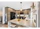 Modern kitchen featuring stainless steel appliances, ample cabinetry, and a stylish island with stool seating at 6678 S Arapahoe Dr, Littleton, CO 80120