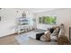Cozy living room with a comfortable sofa, stylish rug, and bright natural light at 6678 S Arapahoe Dr, Littleton, CO 80120