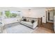 Comfortable living room with a plush sofa, stylish rug, and expansive window view at 6678 S Arapahoe Dr, Littleton, CO 80120