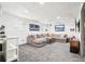Finished basement featuring plush sectional, modern decor, and recessed lighting at 6678 S Arapahoe Dr, Littleton, CO 80120
