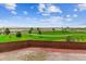 Scenic backyard view with lush greenery, walking path, and a wooden fence, perfect for outdoor enjoyment at 8299 S Kellerman, Aurora, CO 80016