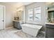 A sleek bathroom with marble features and a freestanding tub offers a spa-like experience at 8299 S Kellerman, Aurora, CO 80016