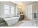 A sleek bathroom with marble features and a freestanding tub offers a spa-like experience at 8299 S Kellerman, Aurora, CO 80016