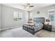 Comfortable bedroom with a ceiling fan, natural light, and neutral carpet at 8299 S Kellerman, Aurora, CO 80016