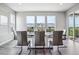 Bright dining room featuring a modern table set and large windows with views of the outdoor space at 8299 S Kellerman, Aurora, CO 80016