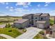 Beautiful home showcasing stone accents, a three-car garage, and manicured landscaping at 8299 S Kellerman, Aurora, CO 80016
