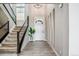 The home's foyer features hardwood floors, a staircase, and a door with decorative window at 8299 S Kellerman, Aurora, CO 80016
