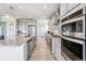 Contemporary kitchen with stainless appliances, granite counters, tile backsplash, and ample cabinet space at 8299 S Kellerman, Aurora, CO 80016