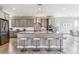 Open kitchen featuring a large island with bar seating and stainless steel appliances at 8299 S Kellerman, Aurora, CO 80016