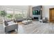 Bright living room with a fireplace, large windows, and modern furniture at 8299 S Kellerman, Aurora, CO 80016