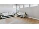 Bright living room featuring neutral walls, carpeted floors, and modern white couches at 8299 S Kellerman, Aurora, CO 80016