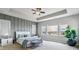 A luxurious main bedroom offers a tranquil retreat with ample natural light and elegant design at 8299 S Kellerman, Aurora, CO 80016