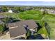 Expansive aerial view of a home overlooking a lush golf course with scenic mountain views at 1743 Homestead Dr, Fort Lupton, CO 80621