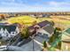 Aerial view of a home situated on a golf course with beautiful landscaping and mature trees at 1743 Homestead Dr, Fort Lupton, CO 80621