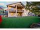 Backyard with turf, a patio, and a multi-story deck, ideal for outdoor living and entertaining at 1743 Homestead Dr, Fort Lupton, CO 80621
