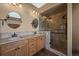 Bathroom with a double sink vanity and a glass-enclosed shower with tiled walls at 1743 Homestead Dr, Fort Lupton, CO 80621