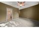 Empty bedroom featuring a bathroom with a shower and toilet through a doorway at 1743 Homestead Dr, Fort Lupton, CO 80621