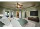 An expansive bedroom features sliding glass doors to a patio, and opens to the kitchen and hallway at 1743 Homestead Dr, Fort Lupton, CO 80621