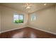 Bedroom with wood floors, multiple windows offering natural light, and ample space at 1743 Homestead Dr, Fort Lupton, CO 80621