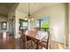 Dining area with a wooden table set, windows, and hardwood floors at 1743 Homestead Dr, Fort Lupton, CO 80621
