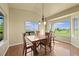 Bright dining room with hardwood floors, a chandelier, and scenic views at 1743 Homestead Dr, Fort Lupton, CO 80621