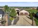 Well-maintained home with manicured landscaping, a stone facade, and a spacious driveway at 1743 Homestead Dr, Fort Lupton, CO 80621