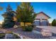 Charming exterior showcasing a well-maintained home with a stone facade and manicured landscaping at 1743 Homestead Dr, Fort Lupton, CO 80621