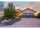 Charming home with a blue two-car garage, beautiful landscaping, and an inviting entrance at 1743 Homestead Dr, Fort Lupton, CO 80621