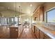 Gourmet kitchen featuring an island with seating, ample cabinet space, and hardwood floors at 1743 Homestead Dr, Fort Lupton, CO 80621