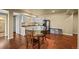 Bright kitchen with white cabinetry, a black refrigerator, and a cozy dining area with table and chairs at 1743 Homestead Dr, Fort Lupton, CO 80621