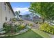 Well-maintained yard with a rock garden, lush lawn, and a white fence at 1743 Homestead Dr, Fort Lupton, CO 80621