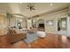 Bright and spacious living room with hardwood floors, a stone fireplace, and open floorplan at 1743 Homestead Dr, Fort Lupton, CO 80621