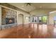 Bright living room featuring a stone fireplace and sliding doors to the deck at 1743 Homestead Dr, Fort Lupton, CO 80621