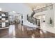 Elegant two-story entryway with curved staircase, hardwood floors, and built-in shelving at 3423 Princeton Pl, Broomfield, CO 80023