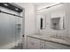 Modern bathroom with granite counters, double sinks, and a glass enclosed shower at 3618 Navajo St, Denver, CO 80211