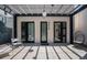 Inviting front entrance featuring a pergola, modern lighting, and stylish black framed doors at 3618 Navajo St, Denver, CO 80211