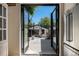 View from the kitchen to the charming backyard featuring a hammock and stylish seating area at 3618 Navajo St, Denver, CO 80211