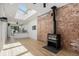 Open living room featuring exposed brick, modern fireplace, and bright skylights at 3618 Navajo St, Denver, CO 80211