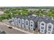 Aerial view of modern townhouses near a scenic lake, highlighting community layout and attractive waterfront location at 3458 W 63Rd Ave, Denver, CO 80221