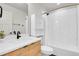Well-lit bathroom with a bathtub-shower combo, modern fixtures, and ample storage space at 3458 W 63Rd Ave, Denver, CO 80221