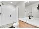 Modern bathroom featuring a walk-in shower, stylish vanity, and contemporary fixtures at 3458 W 63Rd Ave, Denver, CO 80221