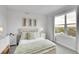 Serene bedroom with a plush bed, matching nightstands, and a large window offering scenic views at 3458 W 63Rd Ave, Denver, CO 80221